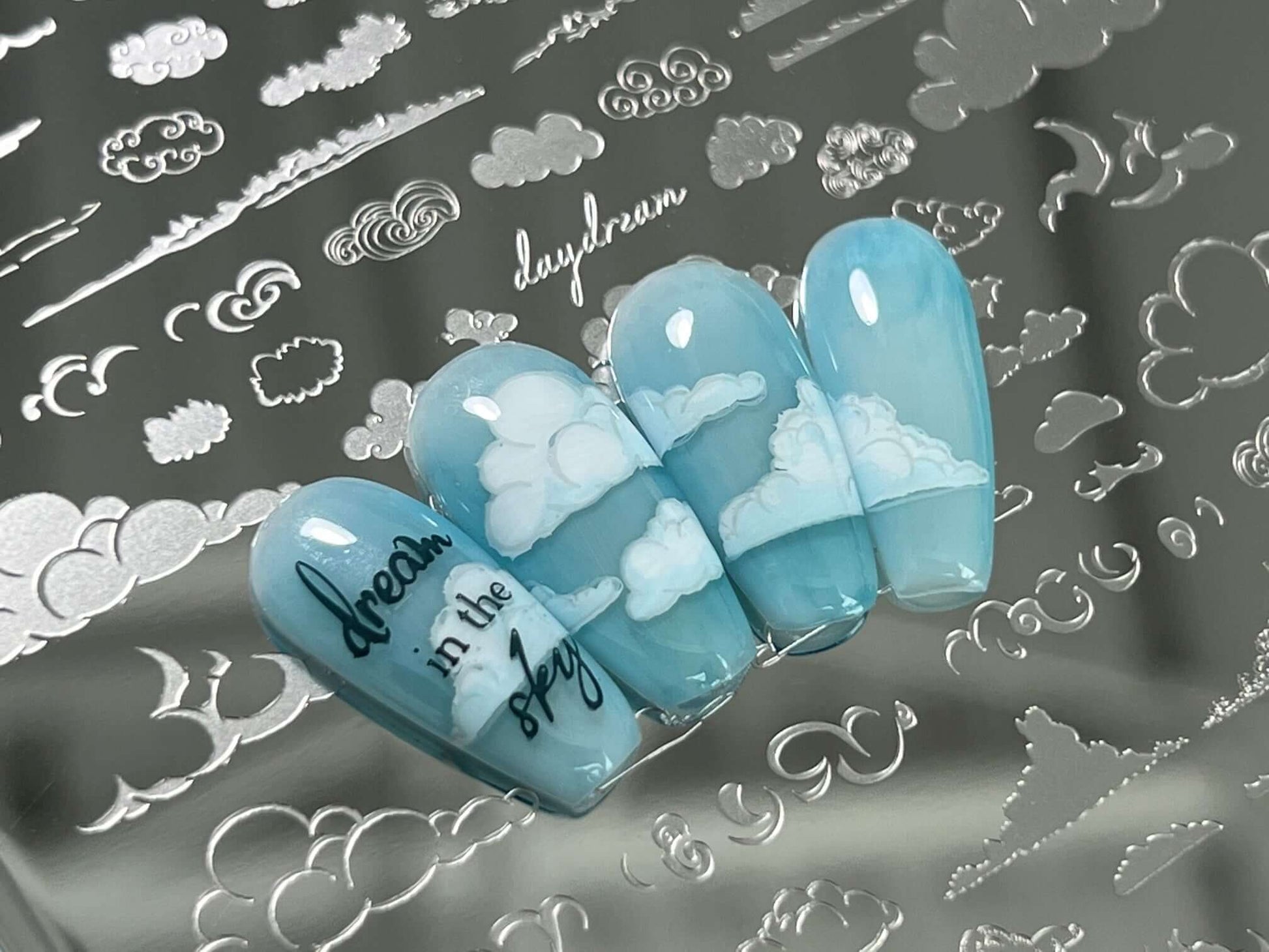 nail-tips-showing-nail-art-designs-of-clouds-with-the-words-dream-in-the-sky