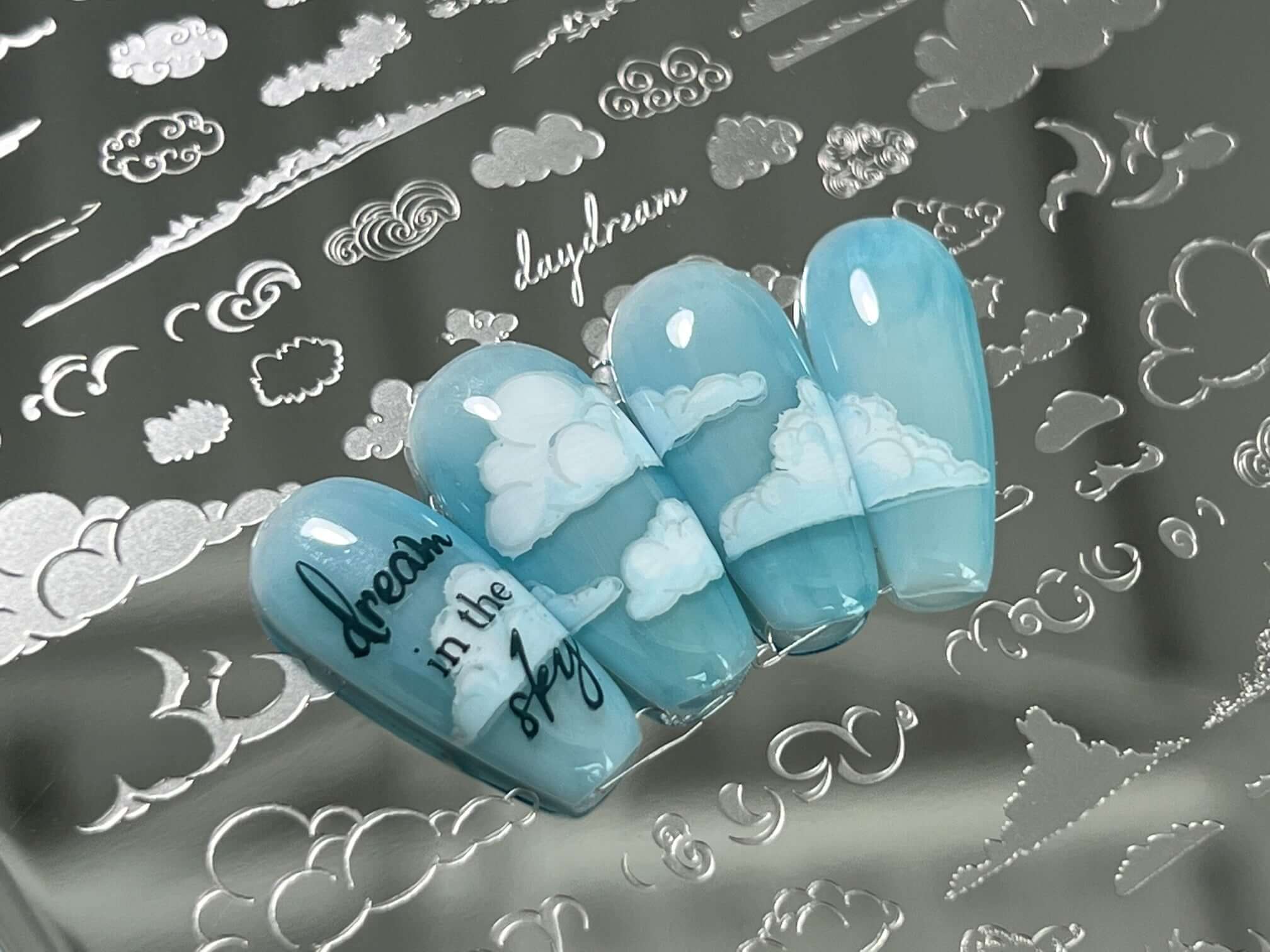 nail-tips-showing-nail-art-designs-of-clouds-with-the-words-dream-in-the-sky