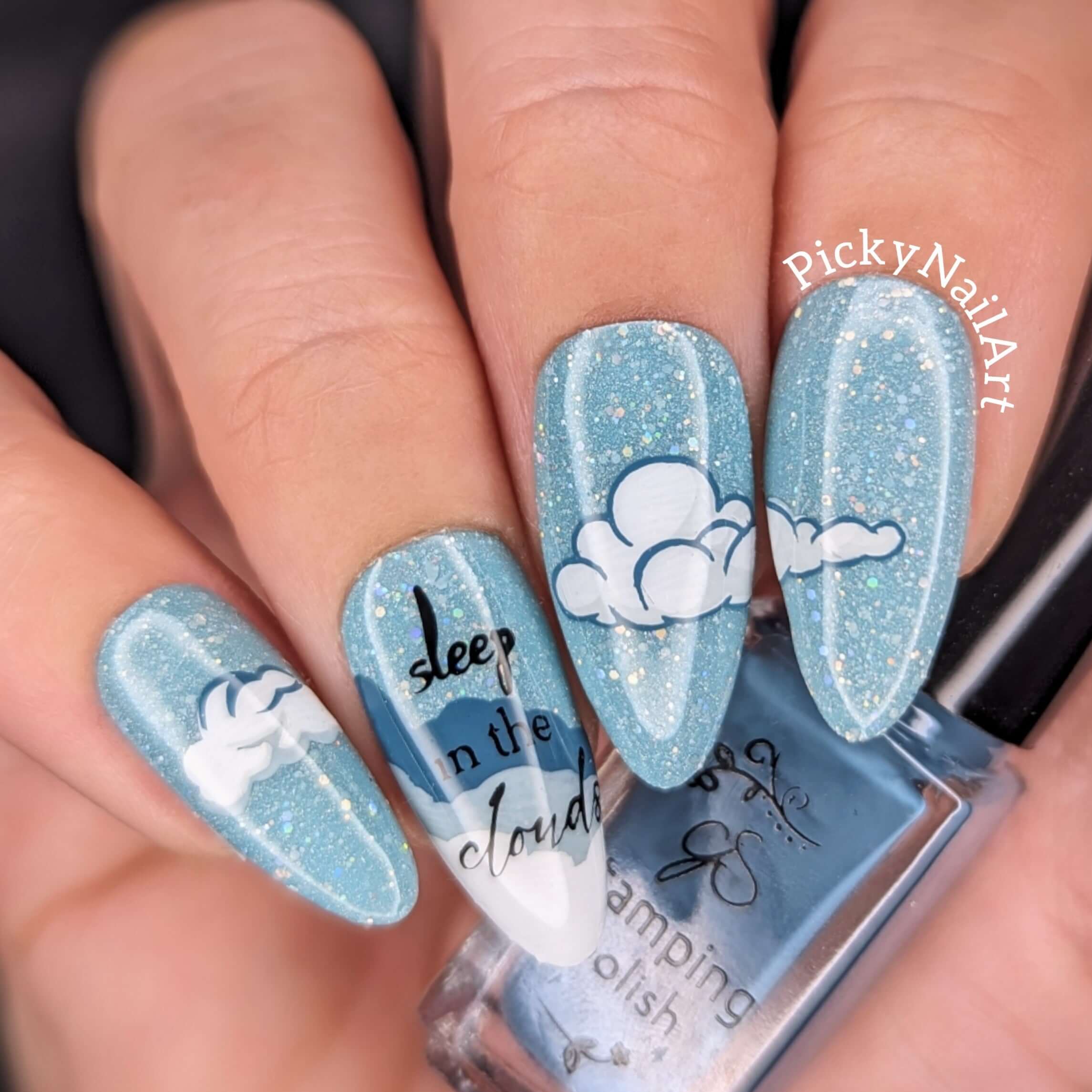 blue-manicure-showing-nail-art-designs-of-clouds-with-the-words-sleep-in-the-clouds
