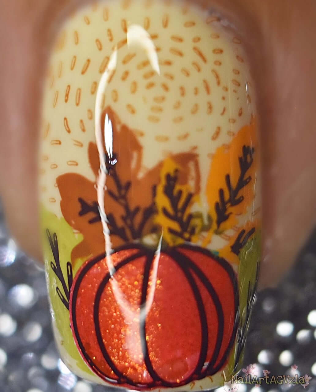 single-manicure-nail-showing-nail-art-design-of-a-pumpkin-with-leaves