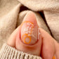 Single-manicured-nail-showing-nail-art-designs-of-modern-boho-shapes-and-leaves