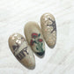 Three-nail-tips-showing-military-themed-nail-art-of-a-navy-ship-and-poppies