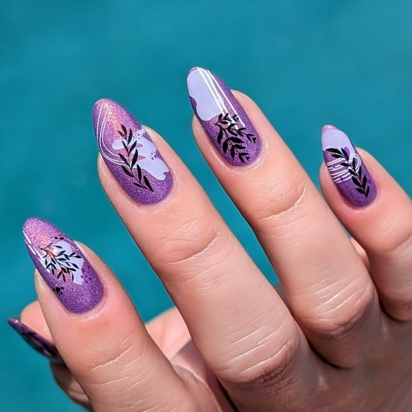 Beautiful-purple-manicure-showing-nail-art-designs-of-abstract-shapes-and-branches-in-modern-boho-style