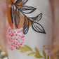 Single-manicured-nail-showing-nail-art-designs-of-branches-with-leaves-and-abstract-dot-patterns