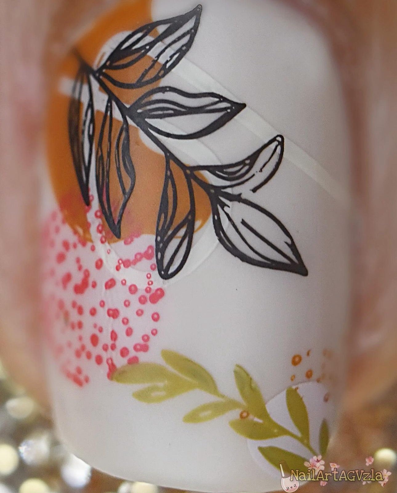Single-manicured-nail-showing-nail-art-designs-of-branches-with-leaves-and-abstract-dot-patterns