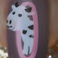 single-manicured-nail-showing-nail-art-design-of-a-cow