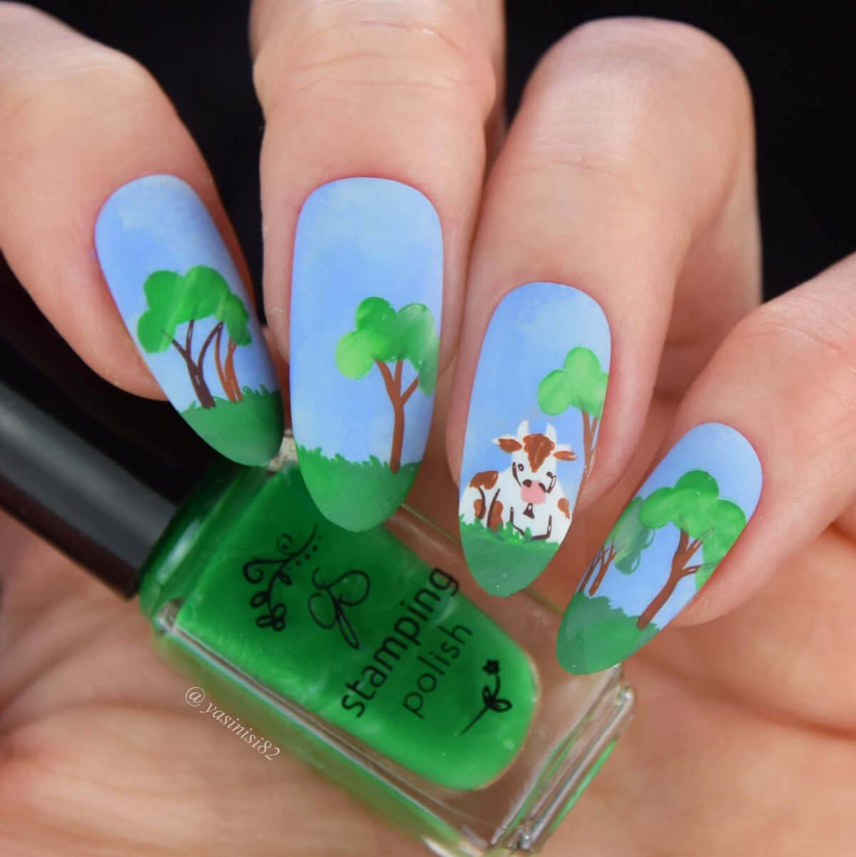 beautiful-manciure-with-nail-art-scene-of-cow-sitting-in-a-field-with-trees