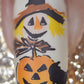 close-up-of-a-single-manicured-nail-with-gorgeous-nail-ar-tdesigns-of-a-scarecrows-face-pumpkin-and-a-black-crow