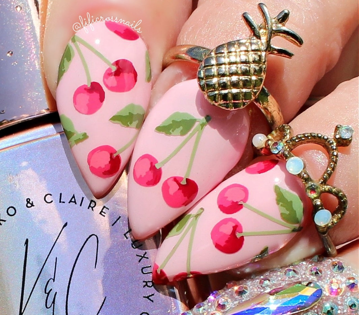 manicured-hand-showing-layered-nail-art-designs-of-paris-of-cherries