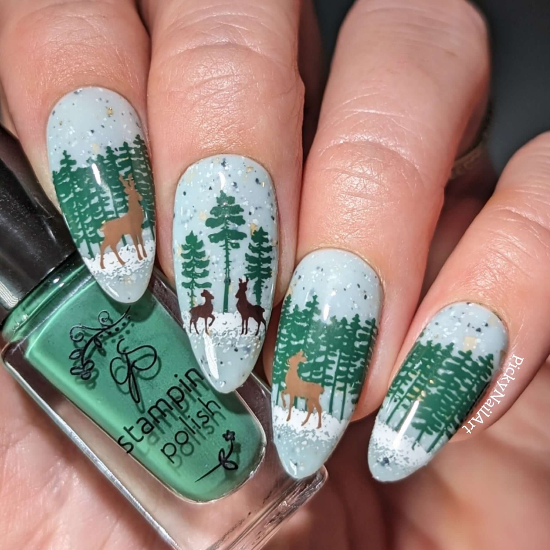 stunning-manciure-with-a-winter-nail-art-scene-of-snow-falling-on-deer-and-woodland-trees