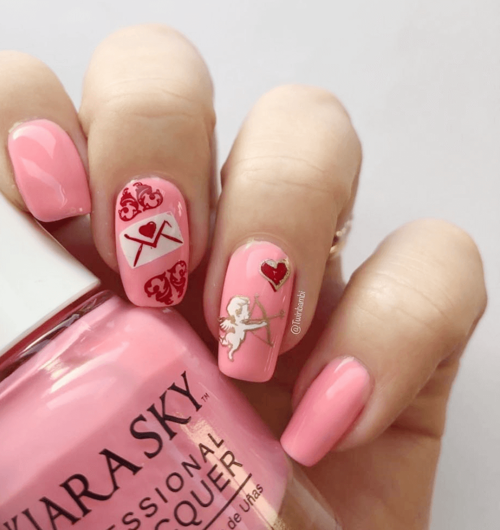 manicure-showing-nail-art-designs-of-a-love-letter-and-cupid-withbow-and-arrow