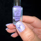 manicured-hand-with-a-nail-art-design-of-a-bow-holding-a-clear-jelly-stamper-polish-bottle
