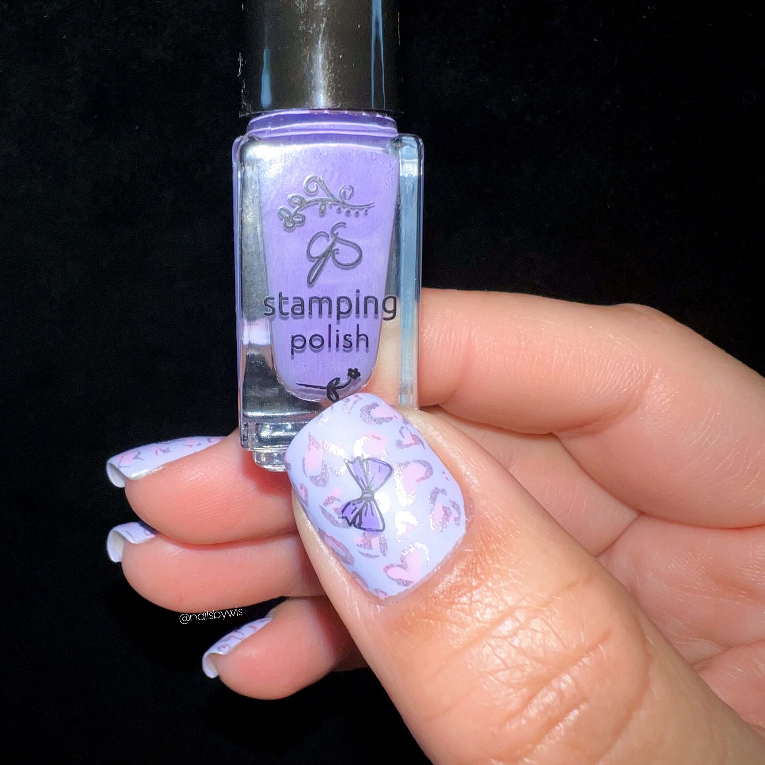 manicured-hand-with-a-nail-art-design-of-a-bow-holding-a-clear-jelly-stamper-polish-bottle