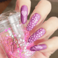 manicure-hand-with-heart-nail-art-designs-holding-an-amour-clear-jelly-stamper