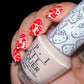 stunning-manicured-hand-with-nail-art-designs-of-lip-stick-print-and-hearts-holding-a-bottle-of-nail-polish