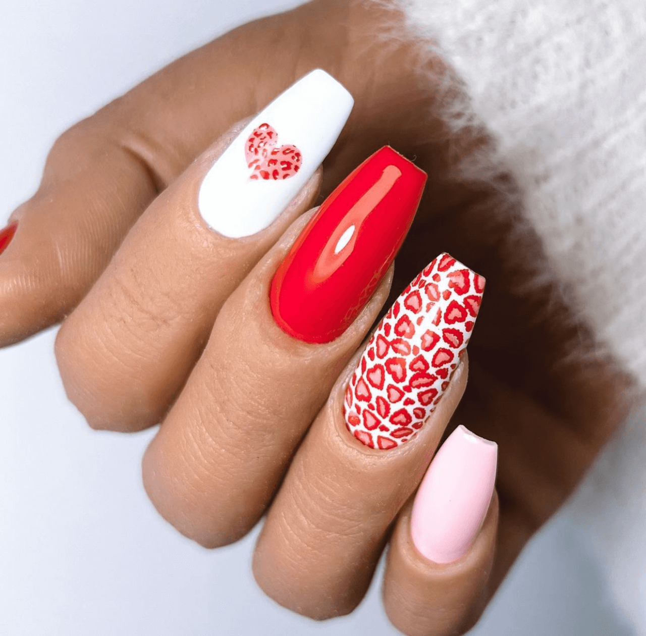 stunning-manciured-hand-with-nail-art-designs-of-animal-print-heart-pattern