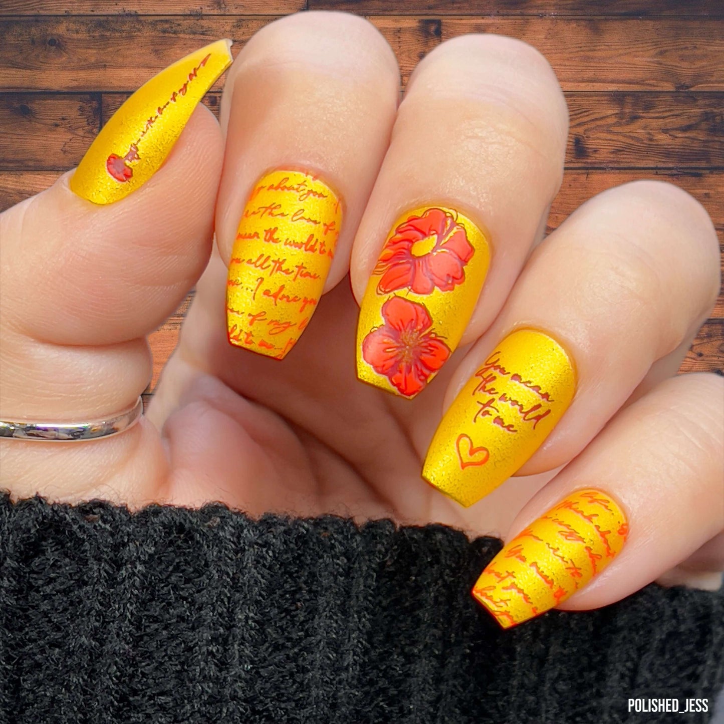 bright-manicure-showing-layered-nail-art-designs-of-flowers-and-script