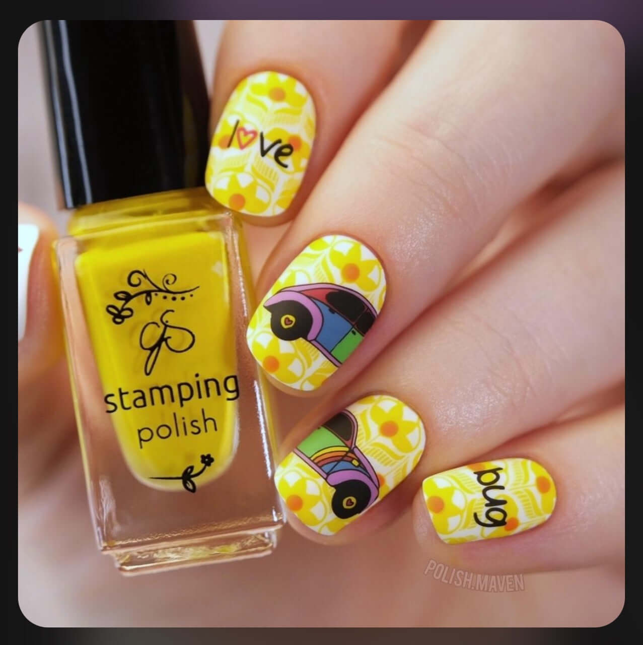 manicured-hand-with-retro-nail-art-designs-of-a-vw-beetle-and-words-love-bug-holding-a-stamping-polish-bottle