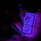 manicured-hand-with-nail-art-designs-of-little-cartoon-hearts-holding a bottle of-glow-in-the-dark-stamping-polish