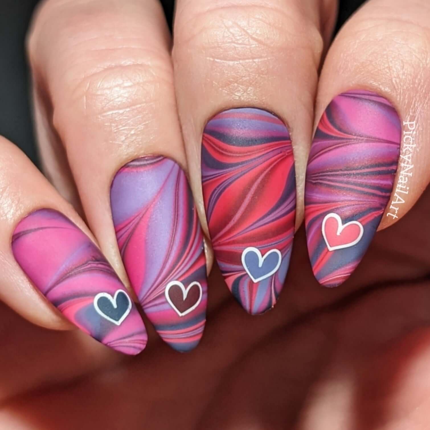 manicured-hand-with-stunning-marble-effect-nail-art-designs-and-hearts