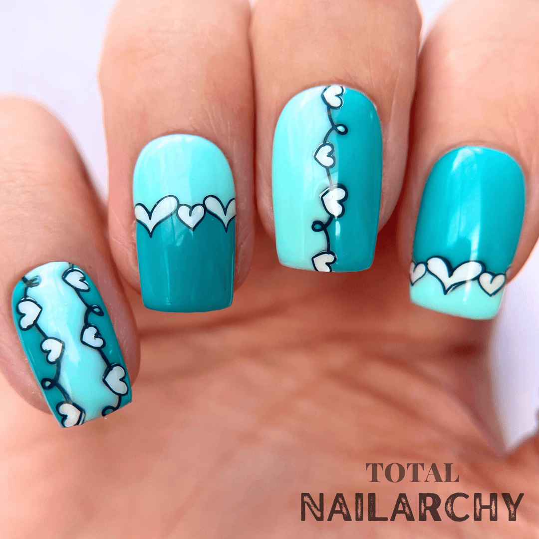 manicured-hand-with-stunning-nail-art-designs-of-hearts-and-french-tip-design
