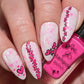 manicured-hand-with-nail-art-designs-of-little-cartoon-hearts-holding a bottle of-stamping-polish