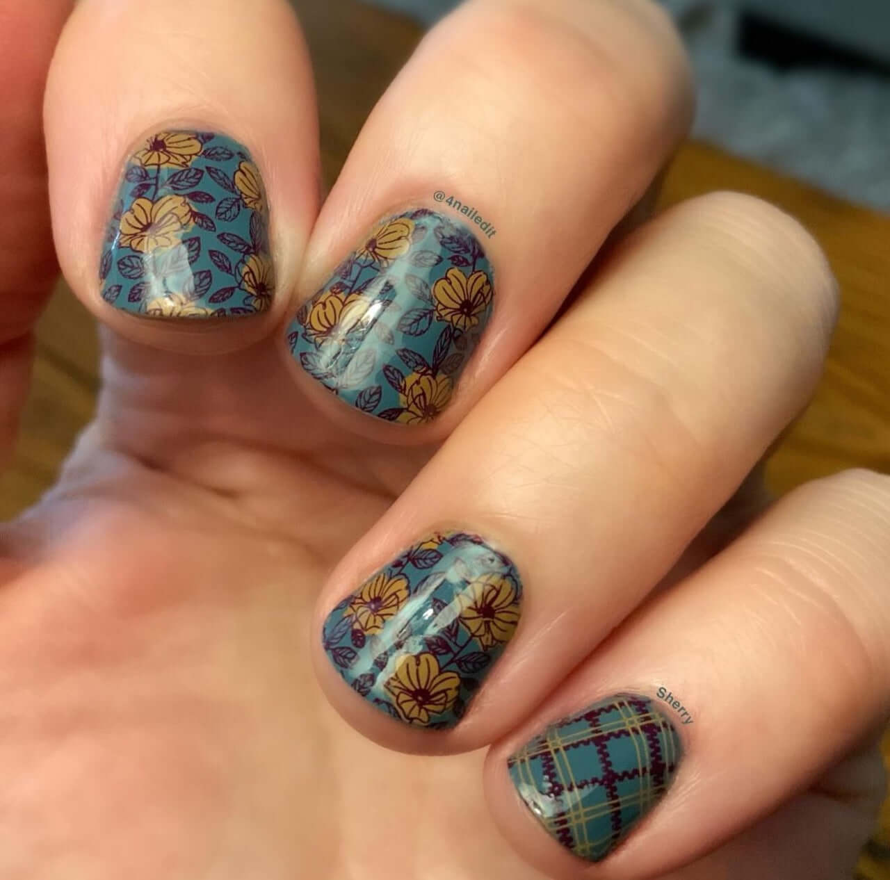 manicured-hand-with-full-coverage-floral-and-plaid-nail-art-designs