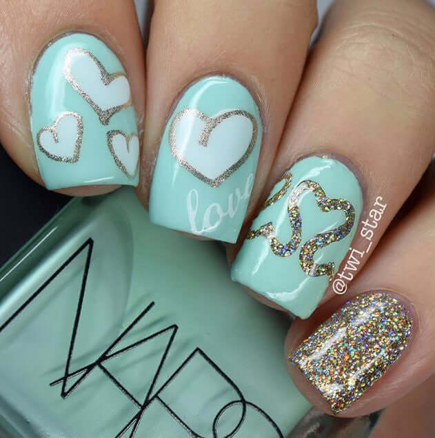 Manicure_with_nail_art_designs_of_hearts_and_the_word_love 