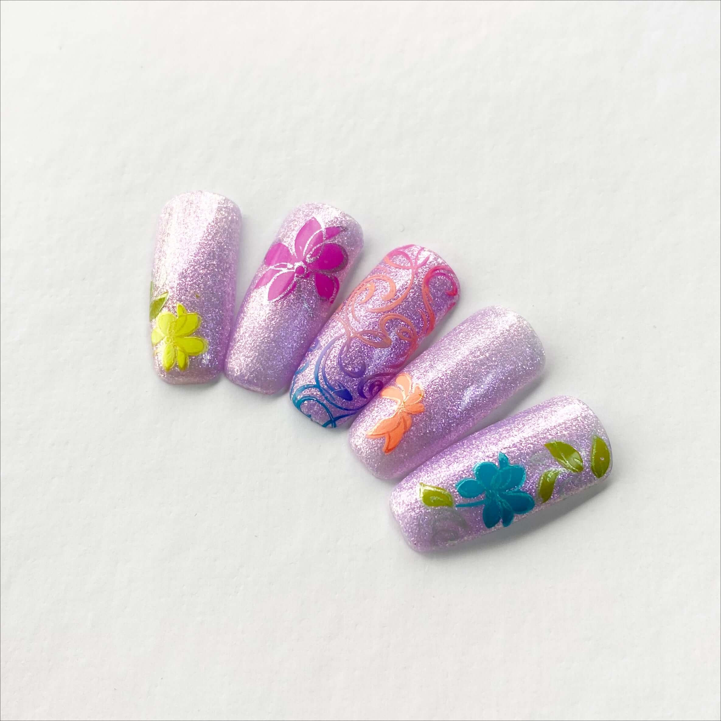 set-of-nail-tips-with-nail-art-stamping-designs-of-flowers-and-swirls