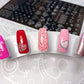 set-of-nail-tips-with-valentines-themed-nail-art-designs-of-different-sized-hearts-and-the-words-be-mine