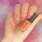 manicured-hand-holding-a-stamping-polish-bottle-with-nail-art-french-tip-designs