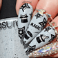 bold-manicure-with-nail-art-designs-of-stars-rabbits-in-black-hats-and-the -word-magic