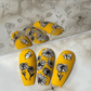 Set-of-three-manicured-nail-tips-with-stunning-nail-art-designs-of-flowers-and-butterflies