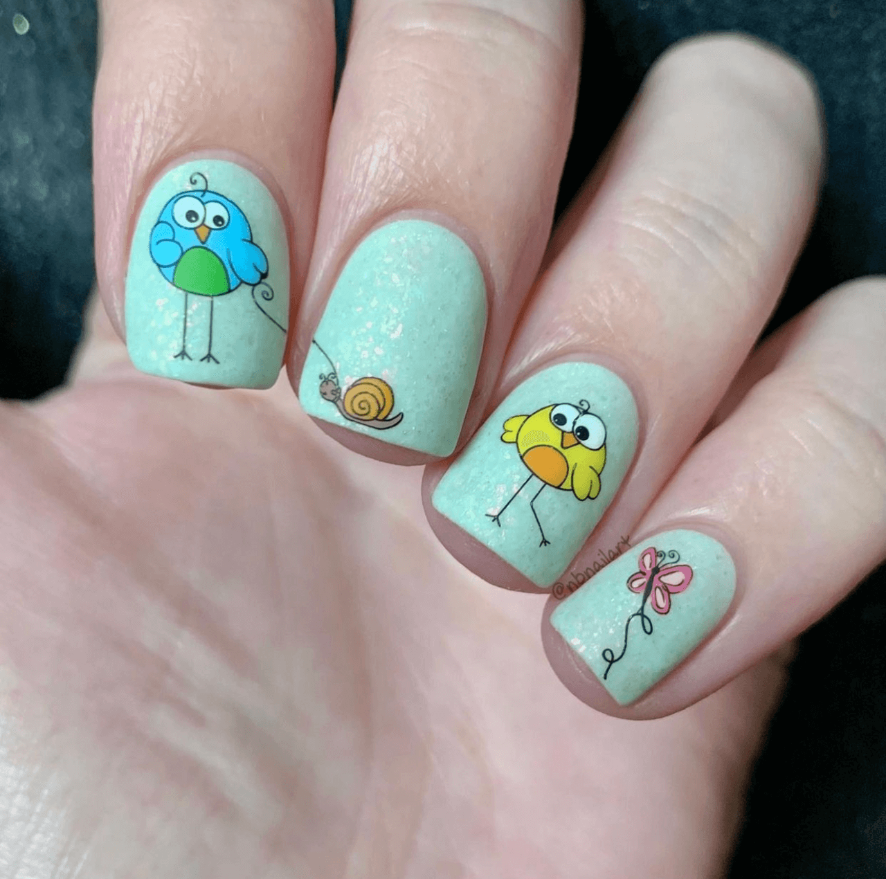 manicure-with-cute-nail-art-designs-of-cartoon-birds-a-butterfly-a-snail