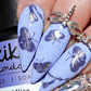 Manicure-with-layered-nail-art-designs-of-swirls-tassels-and-shimmery-butterflies