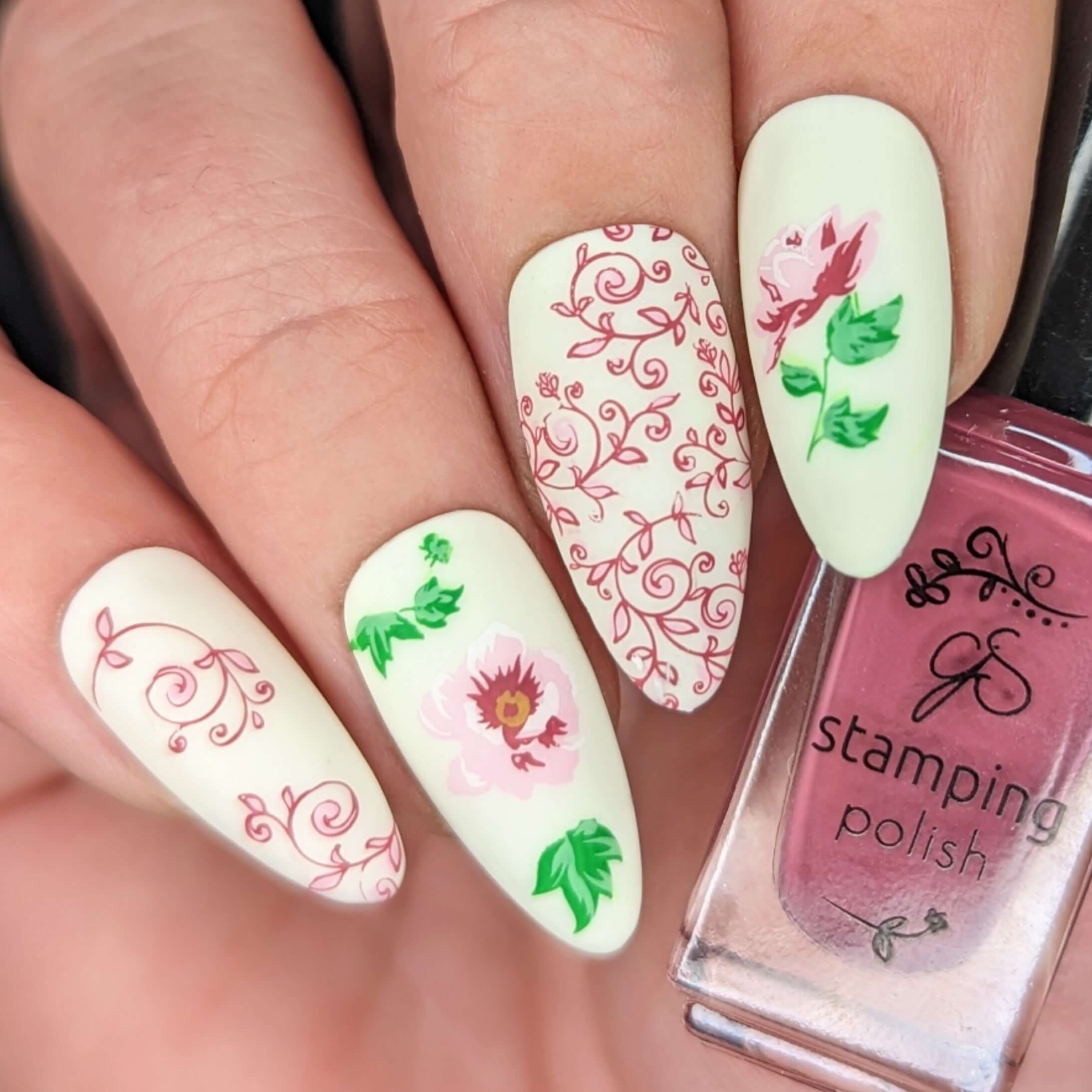 dainty-manicure-showing-nail-art-designs-of-roses-and-swirly-vines