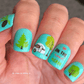 bright-manicure-with-nail-art-designs-of-trees-and-a-camping-trailer-with-words-on-the-road-again