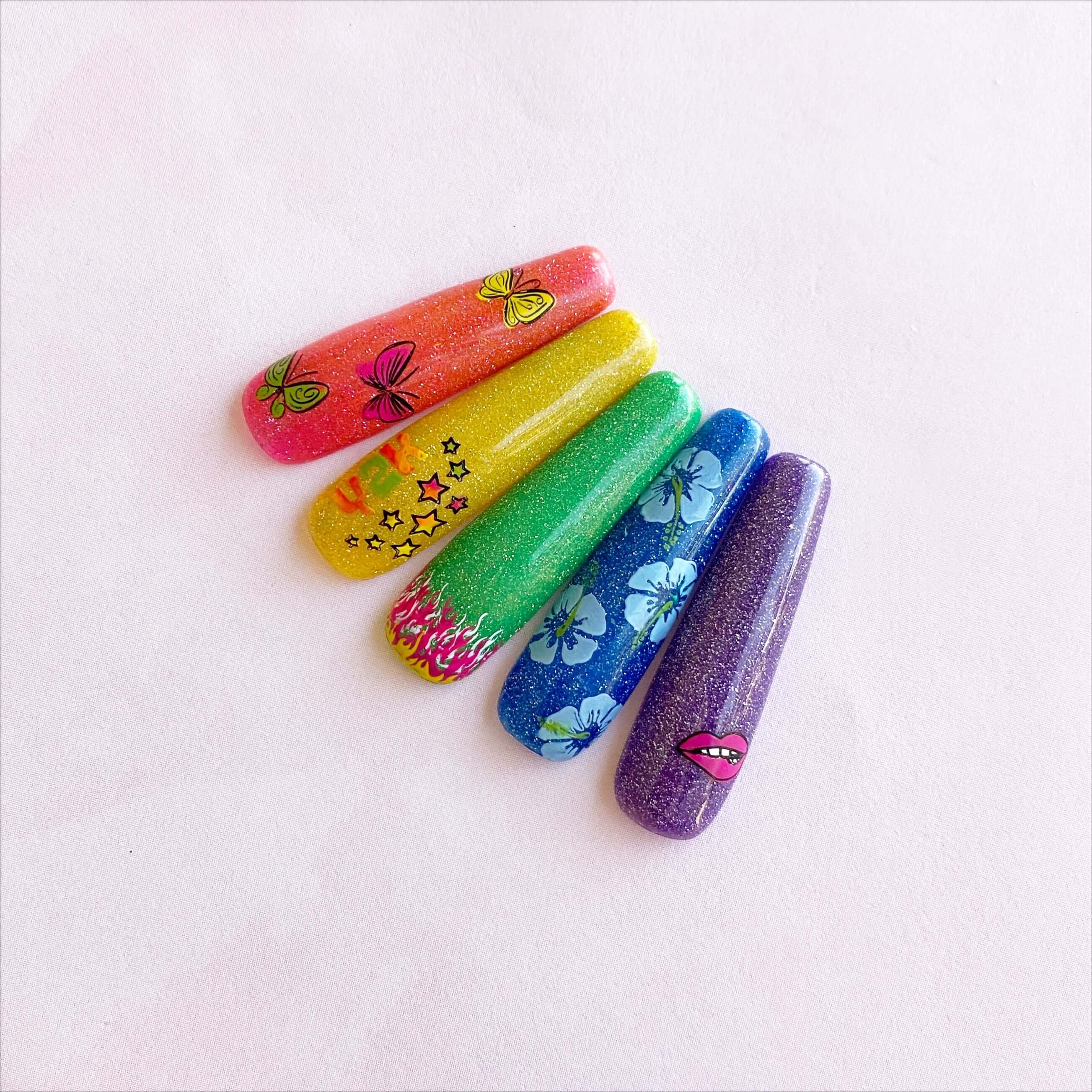 set-of-nail-tips-with-nail-art-designs-of-stars-flames-and-butterflies