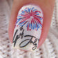 a-single-manicured-nail-showing-nail-art-stamping-designs-of-firworks-and-words-fourth-of-july