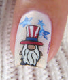 single-manicured-nail-showing-a-nail-art-design-of-a-gnome-wearing-a-usa-hat