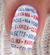 Single-manicured-nail-showing-nail-art-words-of-us-states