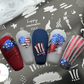 Nail-tips-showing-nail-art-designs-in-red-white-and-blue-of-usa-flag-stars-and-stripes-heart-hat