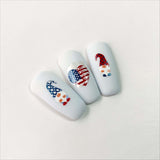Three-nail-tips-showing-nail-art-of-patriotic-usa-designs-of-gnomes-and-starts-and-stripes-heart