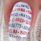 Single-manicured-nail-showing-text-of-the-us-states-in-nail-art