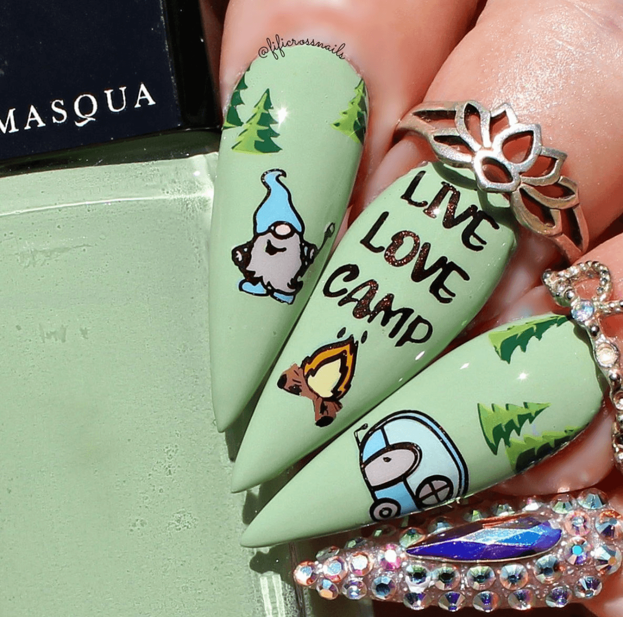 beautfiul-manicure-showing-nail-art-designs-of-a-gnome-camping-with-a-fire-and-words-live-love-camp