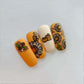 four-nail-tips-with-beautiful-nail-art-designs-of-sunflowers-and-pumpkins