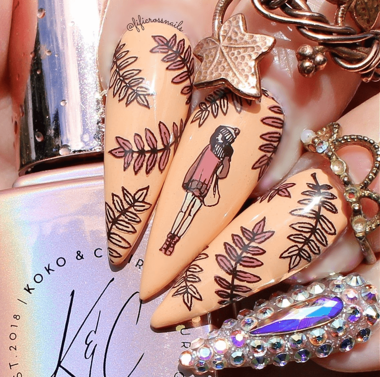 manicure-with-nail-art-designs-of-a-girl-in-a-hat-and-scarf-with-branches