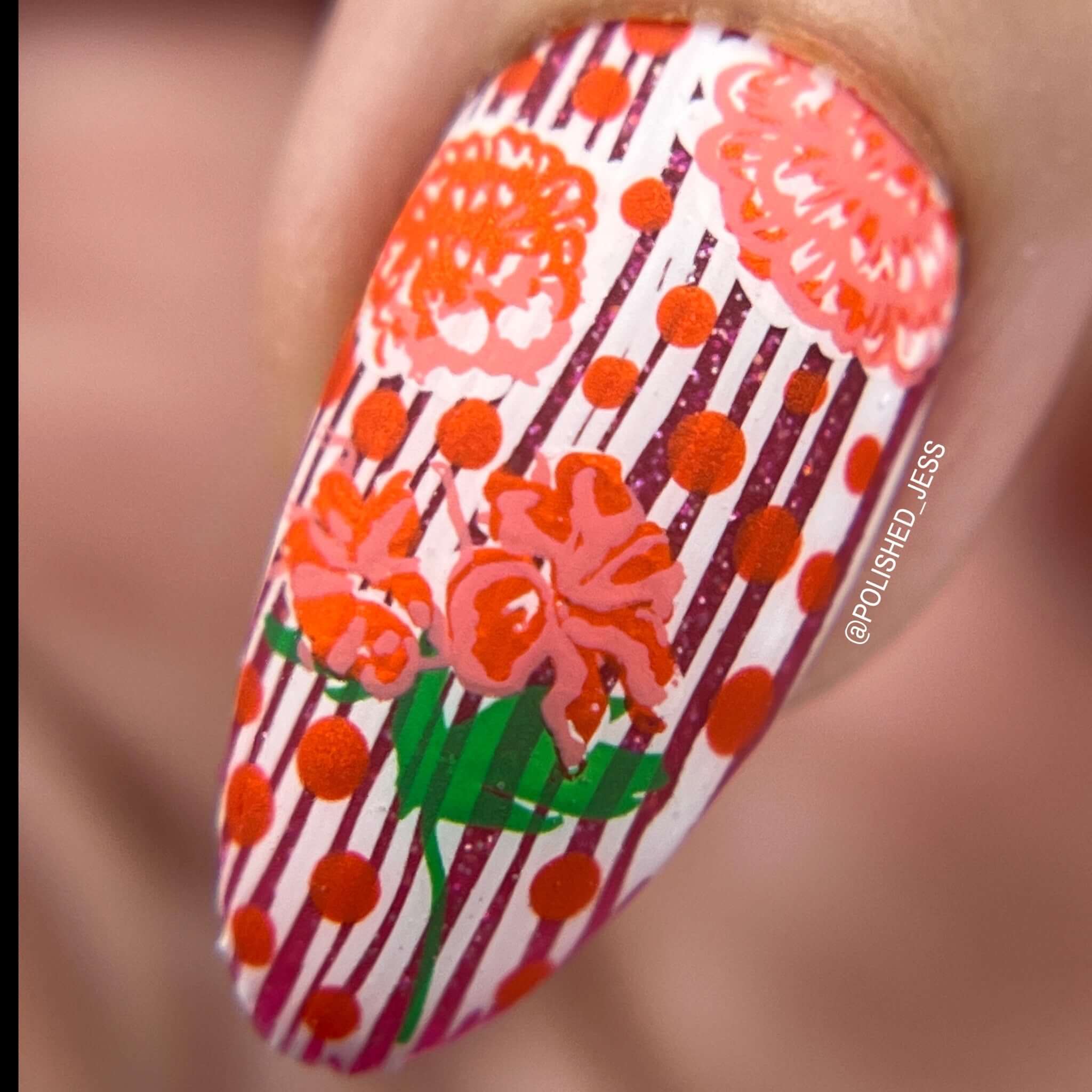 single-manicured-nail-showing-a-nail-art-stamping-design-of-flowers-with-dots-and-stripes