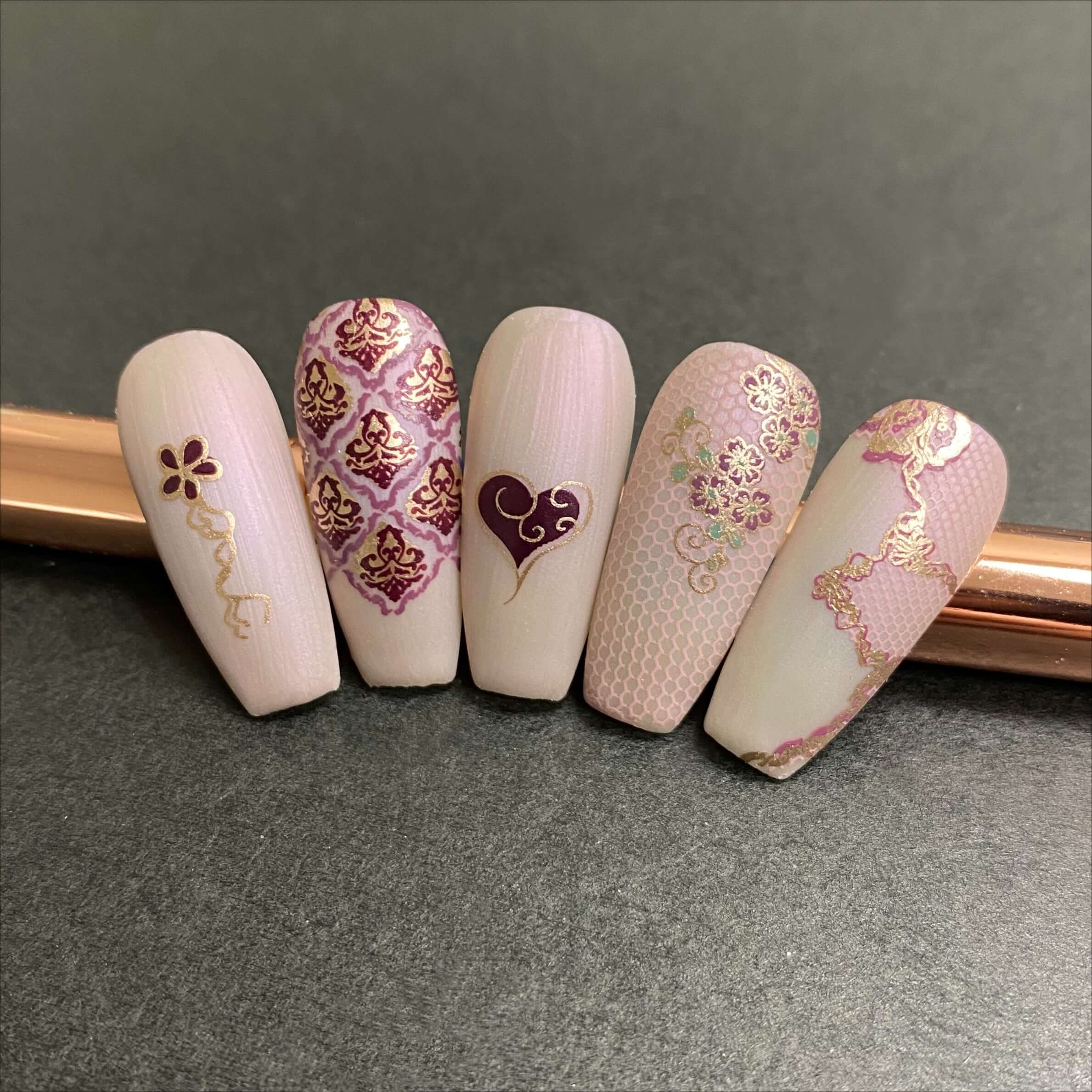 beautiful-manicured-nail-tips-showing-delicate-lace-and-swirl-nail-art-designs