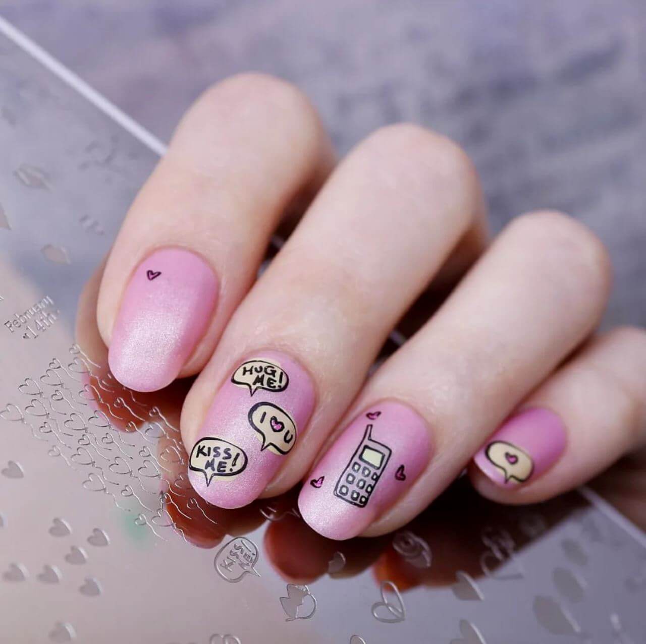 gorgeous-manciure-with-nail-art-designs-of-little-hearts-a-mobile-phone-and-text-bubbles-saying-hug-me-kiss-me-and-i-love-you